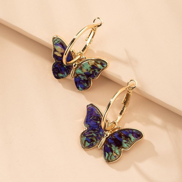Boucles d'oreilles uniques peintes à la main en forme de papillon avec émail et cristal – une touche élégante pour toutes vos tenues